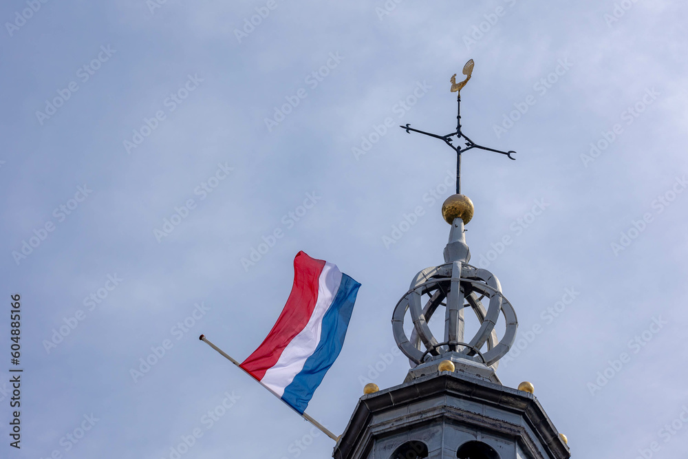 Remembrance of the Dead (Nationale Dodenherdenking) On 04 May every year, National flag of the Netherlands with half-mast, Memorial to victims of the world war two, Dutch flag hanging outside building
