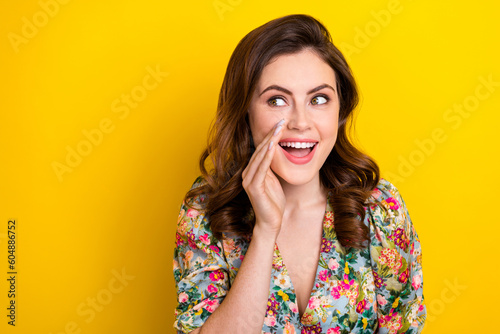 Photo of cheerful gorgeous lady hand near mouth look communicate empty space isolated on yellow color background