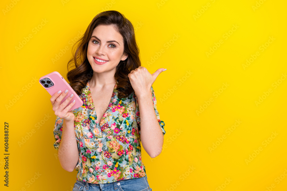 Photo of positive millennial lady using gadget for online order advertise offer empty space isolated bright color background Photo of positive millennial lady using gadget for online order advertise offer empty space isolated bright color background