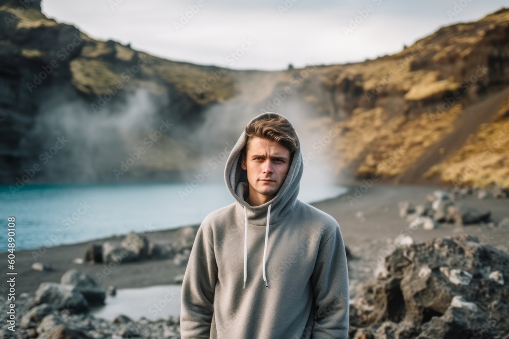 Lifestyle portrait photography of a glad boy in his 30s wearing a stylish hoodie against a scenic hot springs background. With generative AI technology Lifestyle portrait photography of a glad boy in his 30s wearing a stylish hoodie against a scenic hot springs background. With generative AI technology