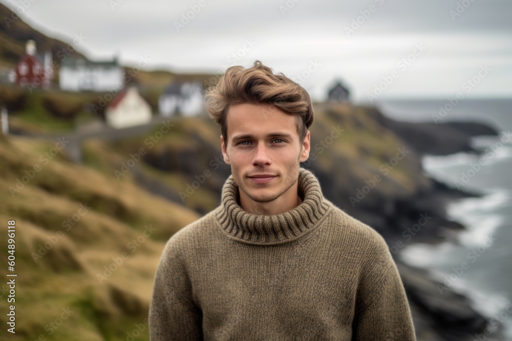 Medium shot portrait photography of a glad boy in his 30s wearing a cozy sweater against a scenic cliffside village background. With generative AI technology