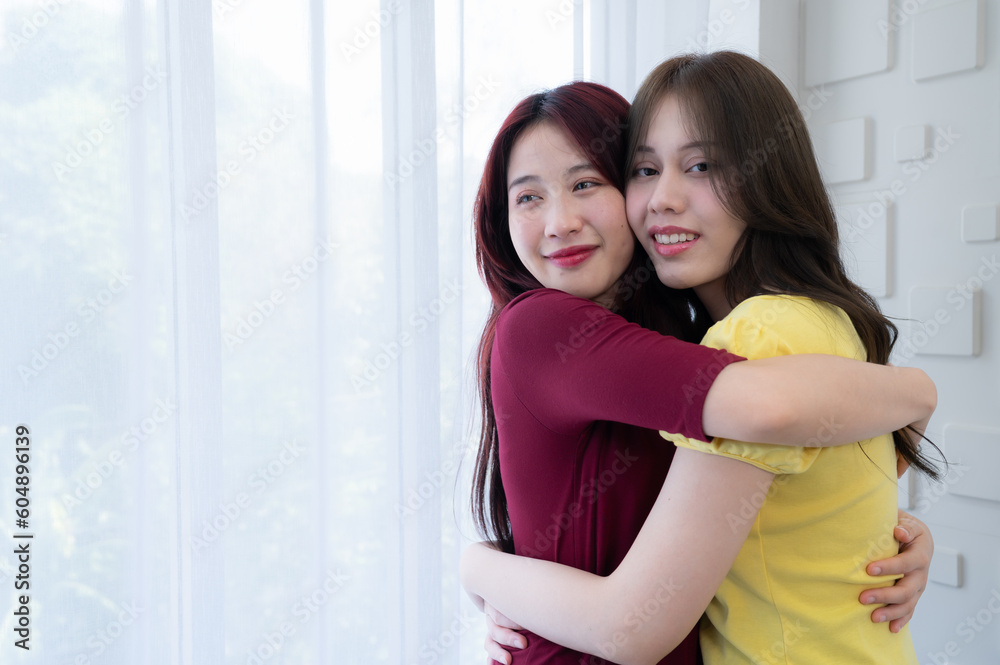 LGBT couples cover rainbow flags around their loved ones to keep warm and gaze out their hotel room windows together. LGBT couples cover rainbow flags around their loved ones to keep warm and gaze out their hotel room windows together.