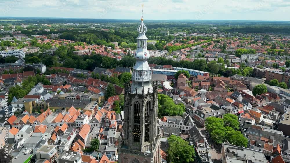 This aerial drone video shows the Lieve Vrouwentoren, a large clock tower in the old city center of Amersfoort. Amersfoort is a beautiful city in Utrecht, the Netherlands. This aerial drone video shows the Lieve Vrouwentoren, a large clock tower in the old city center of Amersfoort. Amersfoort is a beautiful city in Utrecht, the Netherlands.