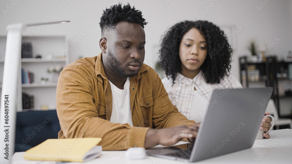 African American couple applying for mortgage loan online to buy a new home African American couple applying for mortgage loan online to buy a new home