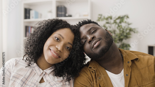 Portrait of an attractive African American couple in love, leaning their heads together