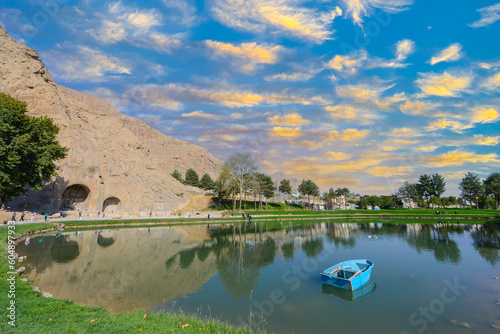 Mountains and clean water lake in beautiful persian valley with historical rocky reliefs on October 12, 2014. Bisotun of Kermanshah Province is the UNESCO World Heritage site photo