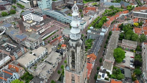 This aerial drone video shows the Lieve Vrouwentoren, a large clock tower in the old city center of Amersfoort. Amersfoort is a beautiful city in Utrecht, the Netherlands. photo