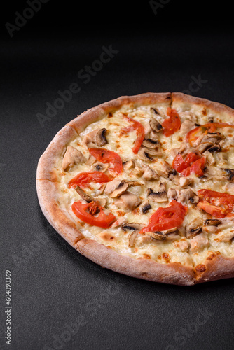 Delicious pizza with chicken, tomatoes and cheese with salt and sauce