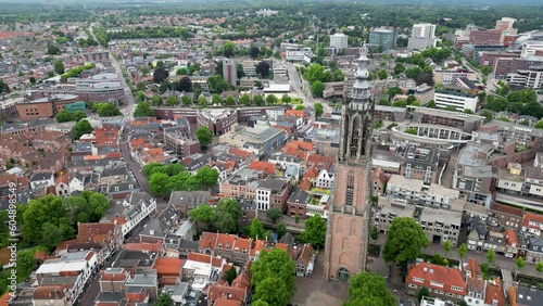 This aerial drone video shows the Lieve Vrouwentoren, a large clock tower in the old city center of Amersfoort. Amersfoort is a beautiful city in Utrecht, the Netherlands. photo