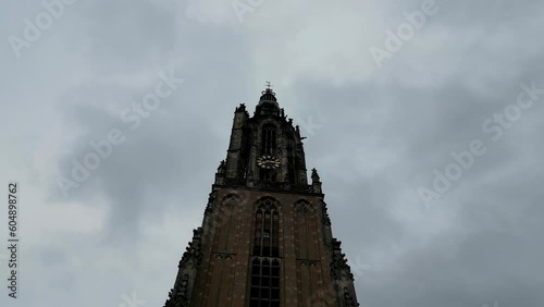 This aerial drone video shows the Lieve Vrouwentoren, a large clock tower in the old city center of Amersfoort. Amersfoort is a beautiful city in Utrecht, the Netherlands. photo