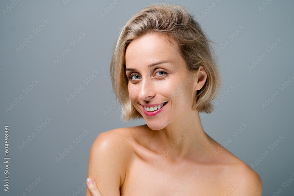 Natural beauty. Blonde woman with healthy skin. No makeup. Grey background. Natural beauty. Blonde woman with healthy skin. No makeup. Grey background.