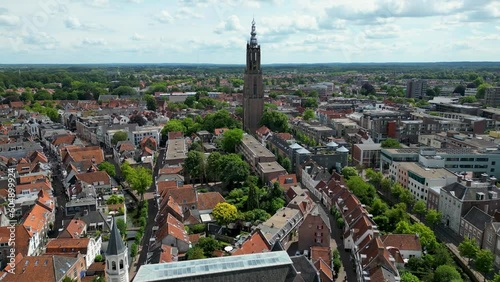 This aerial drone video shows the Lieve Vrouwentoren, a large clock tower in the old city center of Amersfoort. Amersfoort is a beautiful city in Utrecht, the Netherlands. photo