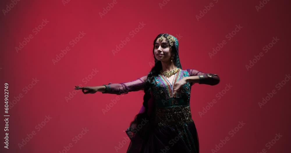 Young Indian woman dances with energy and expression, showing her skill and passion for the dance. Her vibrant smile and graceful movements create a joyful and Charming experience. Young Indian woman dances with energy and expression, showing her skill and passion for the dance. Her vibrant smile and graceful movements create a joyful and Charming experience.