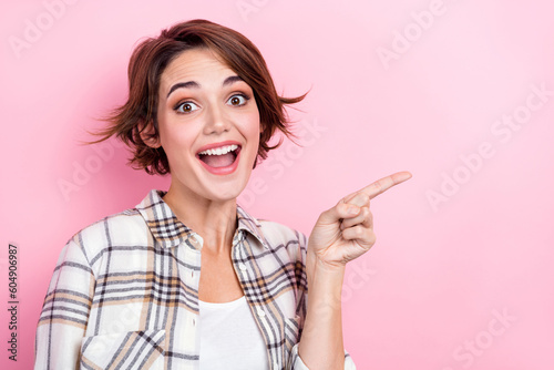 Closeup photo of astonished marketer woman direct finger creative design company buy shutterstock cadres isolated on pink color background