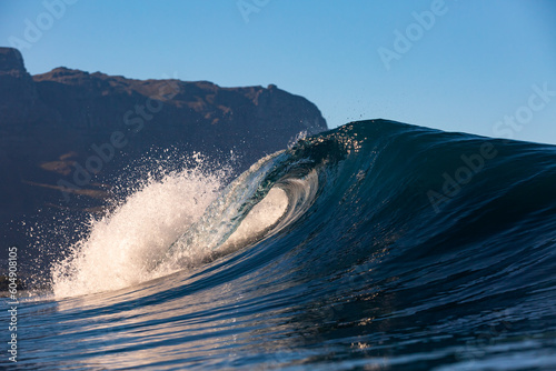 perfect wave breaking with blue sky background