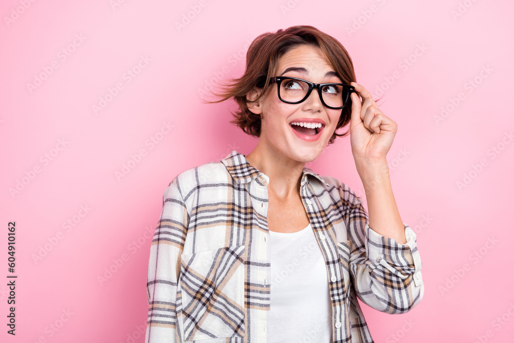 Photo of young boss woman bob brown hair touch glasses surprised watch empty space good news for company isolated on pink color background