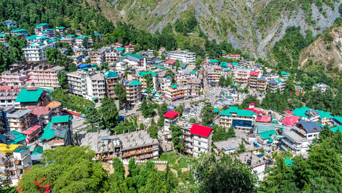 McLeodganj, Dharamshala - Aerial view of McLeodganj of Himachal Pradesh surrounded by cedar forests and Dhauladhar mountain range photo