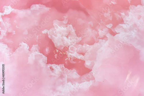 Light pink blurred background made of pink jade or Nephrite