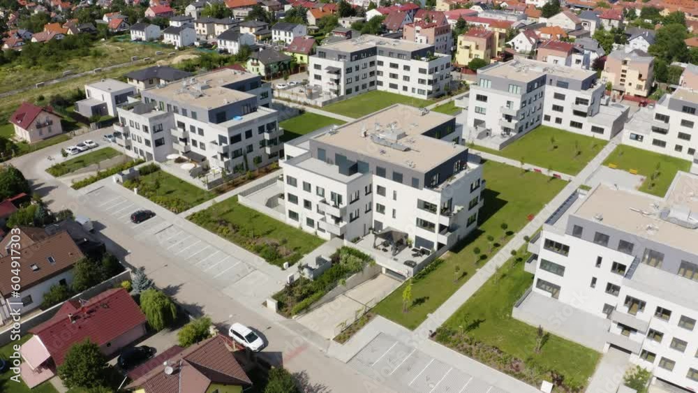 Aerial view from a drone - condominiums in an idyllic, picturesque town on a sunny day - drone drifts to the left Aerial view from a drone - condominiums in an idyllic, picturesque town on a sunny day - drone drifts to the left