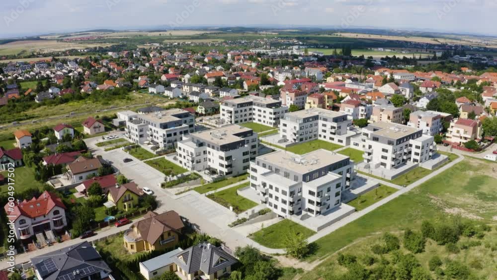 Aerial view from a drone - condominiums in an idyllic, picturesque town on a sunny day - drone drifts to the right Aerial view from a drone - condominiums in an idyllic, picturesque town on a sunny day - drone drifts to the right