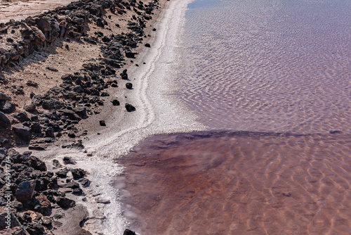 Coastal water area with dark sand and hardened volcanic lava. Canary Islands.