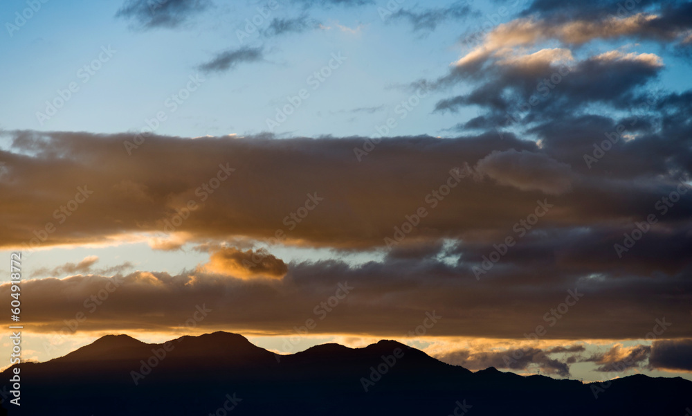 Beautiful sunset sky with clouds in mountains