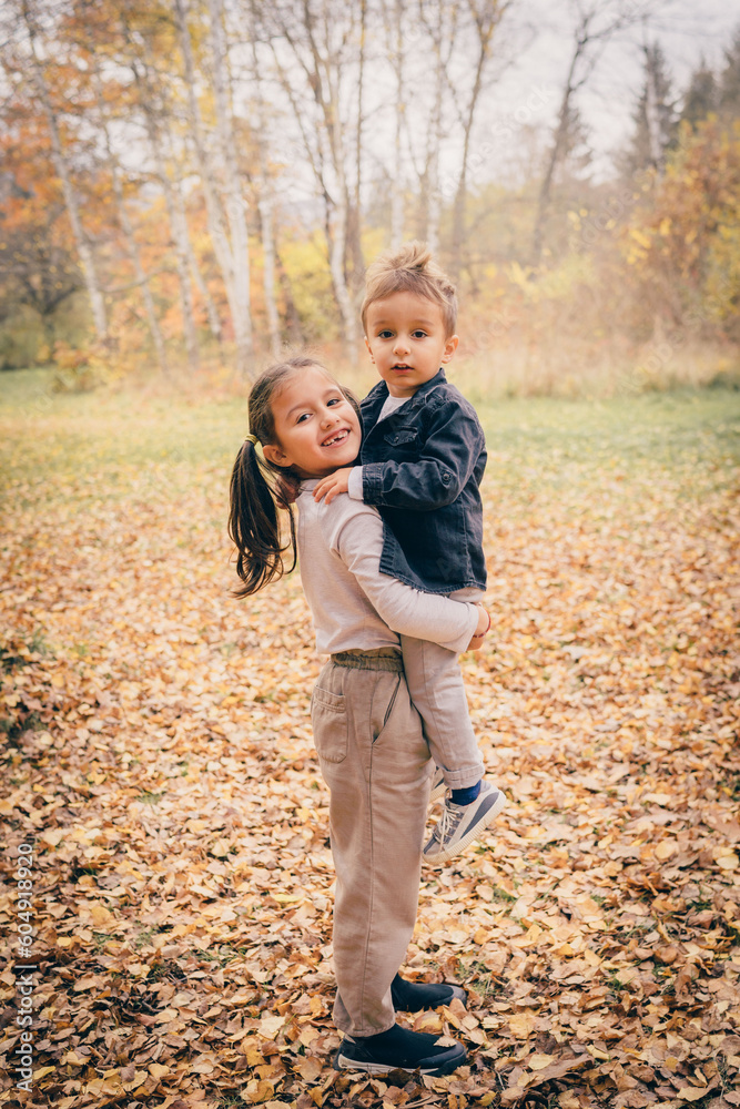 Fototapeta premium Brother and sister playing in the forest and smiling 