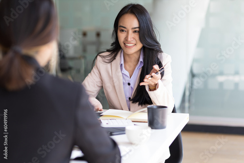 Businesswoman discussing with colleagues in the office, job interview.