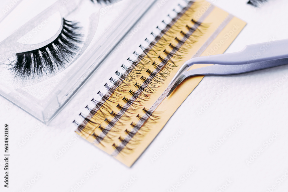 Artificial false fluffy eyelashes with tweezers. Artificial false fluffy eyelashes with tweezers.