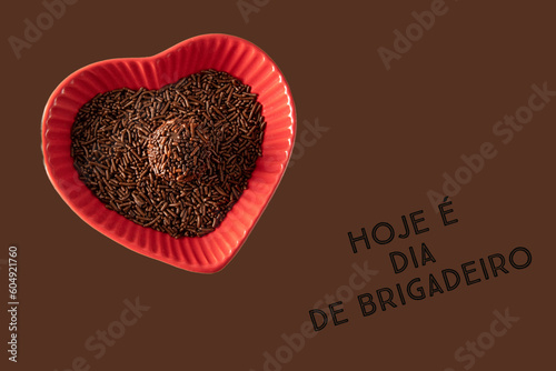 Brigadeiro (Brigadeiro) Traditional Brazilian sweet. Chocolate sweets on dark background written in portuguese 