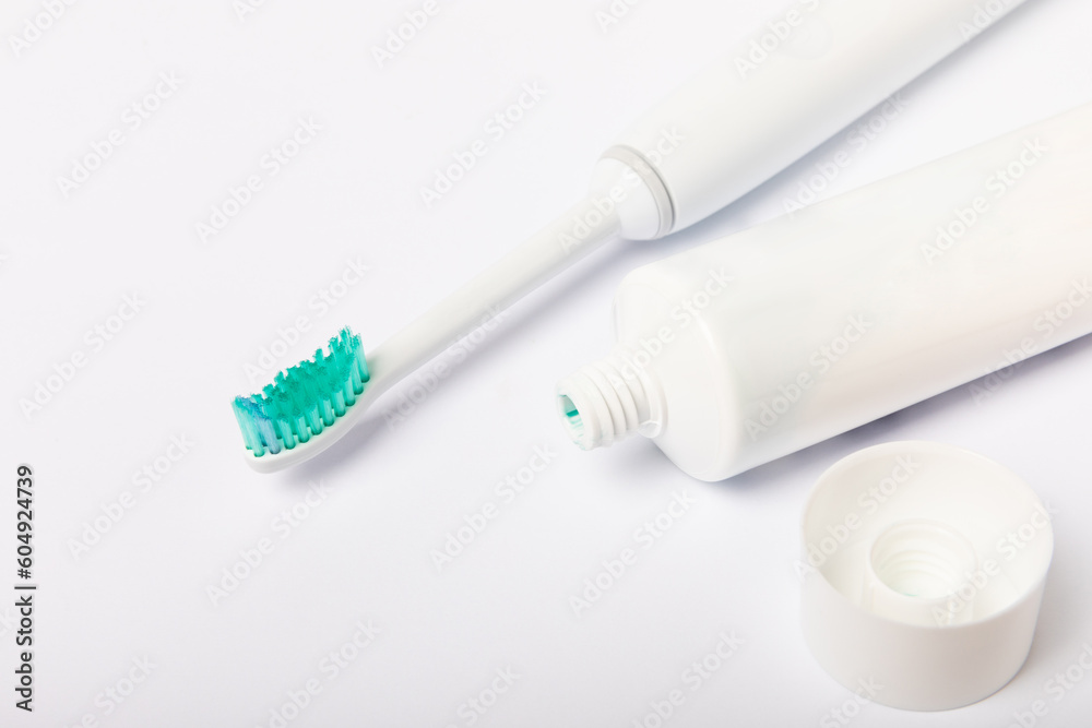 electric toothbrush and toothpaste isolated on white background. Flat lay. Oral hygiene. Oral care kit. Dentist concept. Place for text. Place to copy. electric toothbrush and toothpaste isolated on white background. Flat lay. Oral hygiene. Oral care kit. Dentist concept. Place for text. Place to copy.