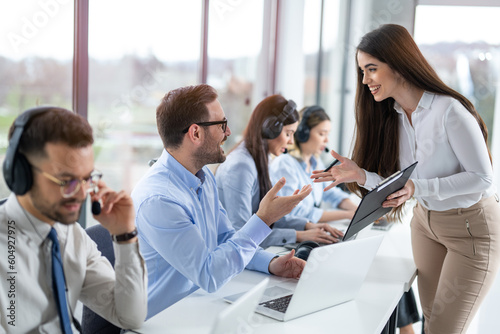 фотографія Professional businesswoman leading and supervising a group of Call Center employees, providing guidance and generating reports at office