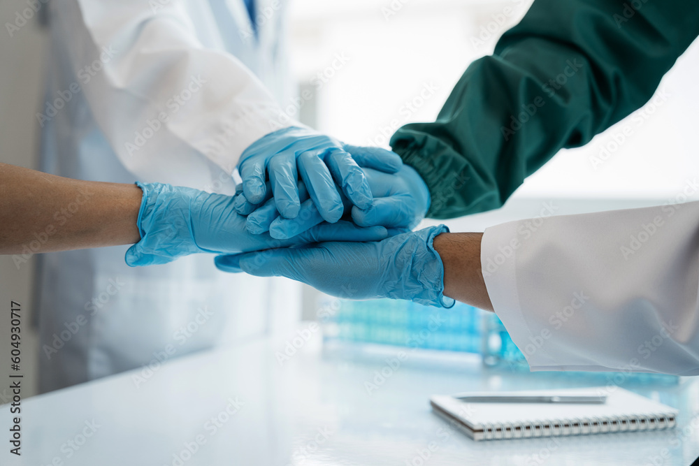 Doctors shaking hands in unity at the hospital. Doctors shaking hands in unity at the hospital.