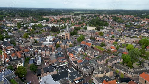 This aerial drone video shows the small town of Barneveld. Barneveld is a rural town in Gelderland, the Netherlands. It is mostly residential area but has a large church in the center. 