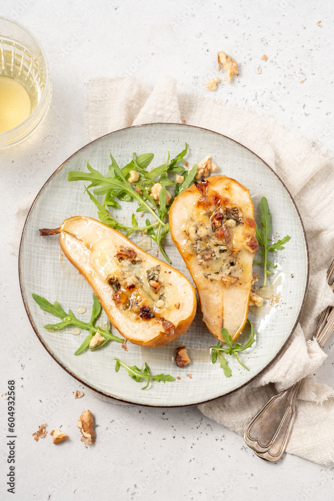 Pear baked with blue cheese, honey and walnuts with arugula salad Pear baked with blue cheese, honey and walnuts with arugula salad