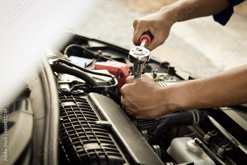 Mechanic open vehicle hood checking up auto mobile, fixing a car at home,Repair and service photo