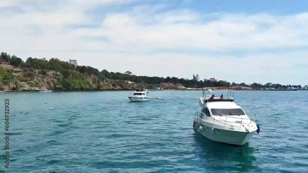 Pleasure motorboats sail in the blue Mediterranean sea Pleasure motorboats sail in the blue Mediterranean sea