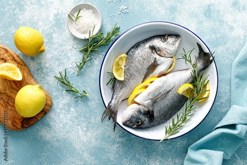 Photography Fresh raw dorado fish cooking with lemon and rosemary