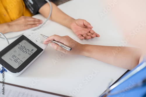 Doctor checking  patient arterial blood pressure. Health care.