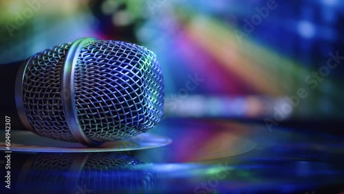 Close-up of microphones on the vinyl record with multicolor lighting and blurry background