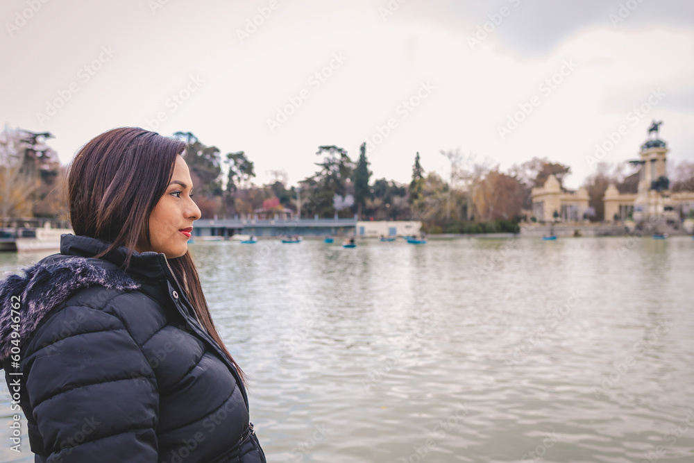 Young woman looking at the horizon next to a lake