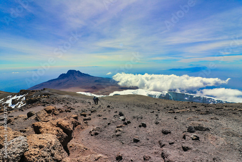 Fotografie Hikers descend towards Stella Point after summiting on Kilimanjaro with Mawenzie