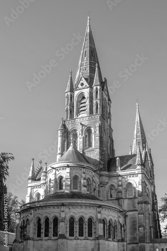 The tall Gothic spire of an Anglican church in Cork, Ireland. Neo-Gothic Christian religious architecture. Cathedral Church of St Fin Barre, Cork - One of Ireland’s Iconic Buildings. Black and white.