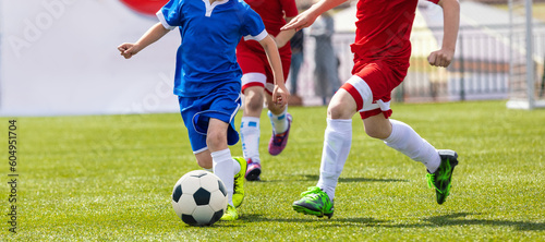 Soccer Players in a Duel. Elementary Age Kids in Soccer Clubs of Soccer Academies. Two Children Sports Team Kicking Football Match on Grass Pitch