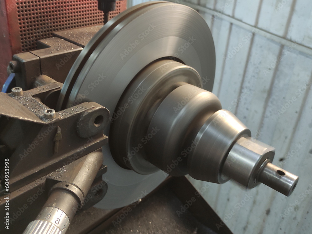 Car brake disc grinding on a lathe machine. Brake discs runout elimination