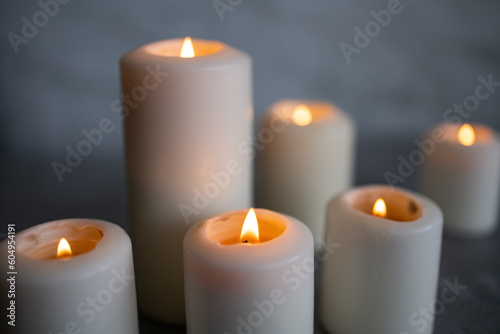 White candles on a gray background