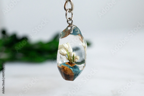 Real flowers in epoxy resin, jewelry photo