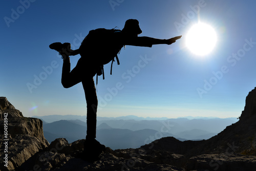 silhouette of successful mountaineer on the summit