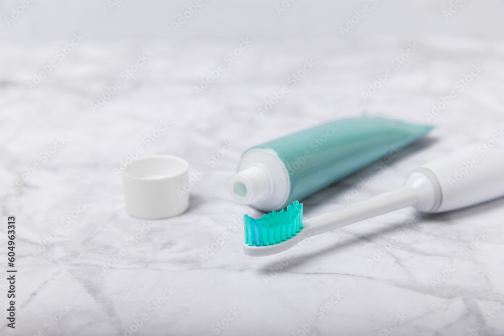 Toothbrush and tube of toothpaste on marble background with copy space. Flat lay. Oral hygiene. Oral Care Kit. Dentist concept. Place for text. Place to copy. Toothbrush and tube of toothpaste on marble background with copy space. Flat lay. Oral hygiene. Oral Care Kit. Dentist concept. Place for text. Place to copy.