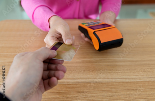 Close up of hand paying with credit card